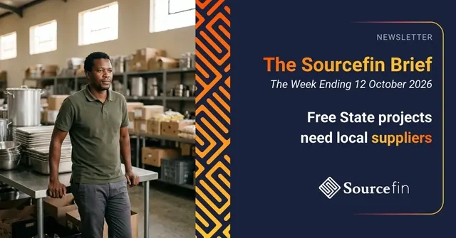 Small business owner leaning on a steel counter in a stockroom stacked with boxes and kitchen supplies