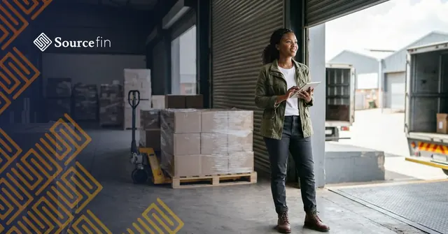 SME owner checks a confirmed order at a loading bay before a specialist funder pays suppliers